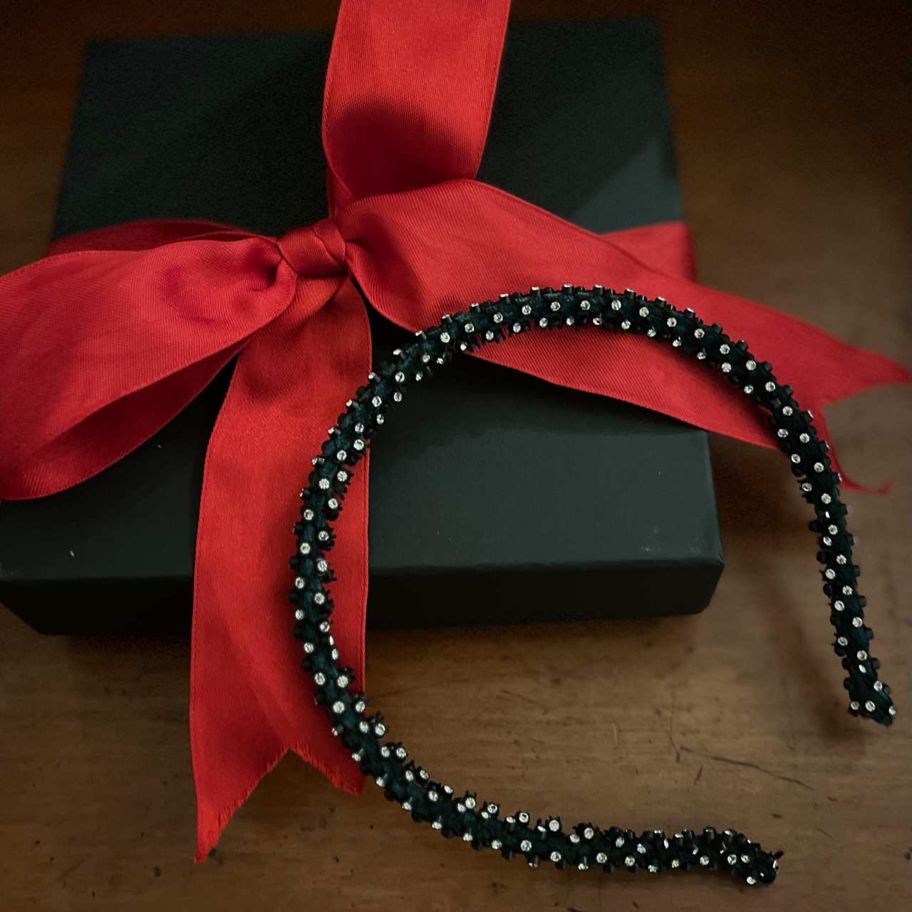 fine sparklky band with diamantes resting on a black box as present.
